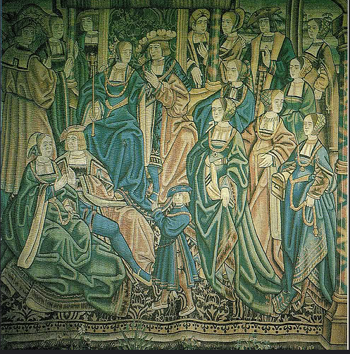 A tapestry with decorative emroidery of the wedding of Catherine of Aragon to her first husband, Arthur Tudor, Prince of Wales. Catherine and Arthur sit in the upper left of the image. Catherine wears a long blue gown and Arthur wears similarly extravagant blue and red men's clothing and a plumed hat. 